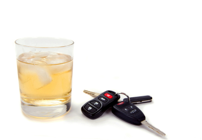 car keys laying next to an alcoholic drink