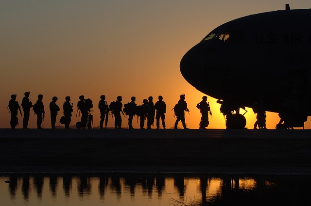 group of soldiers walking toward a plane