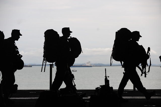 military members walking along the beach