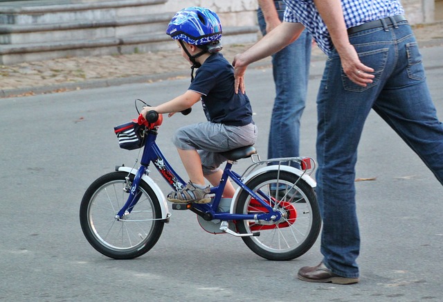 child learning how to ride a bicycle