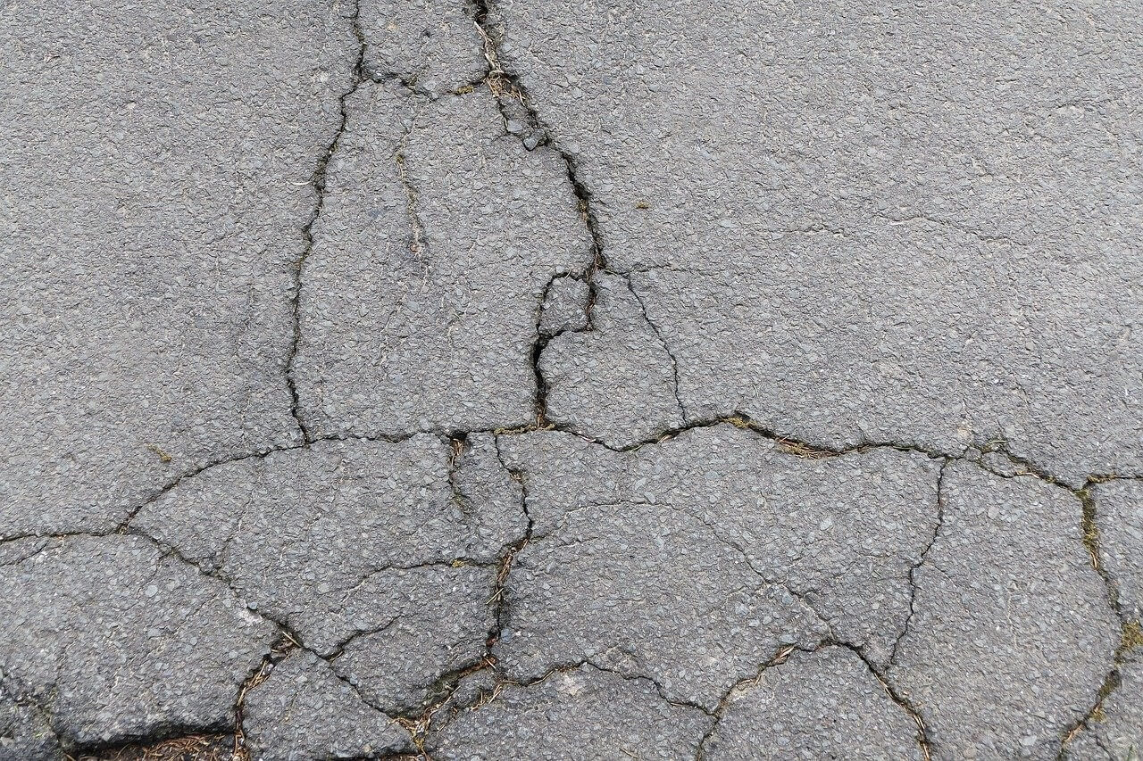 hazardous cracks in the road's asphalt