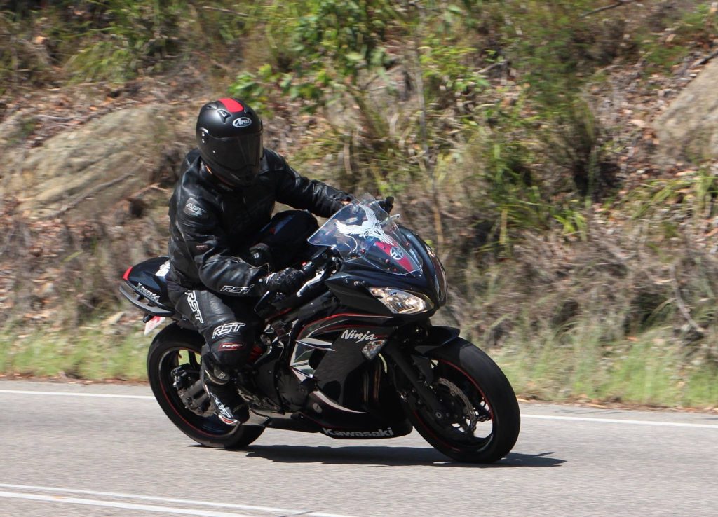 motorcyclist in head-to-toe gear driving on the road
