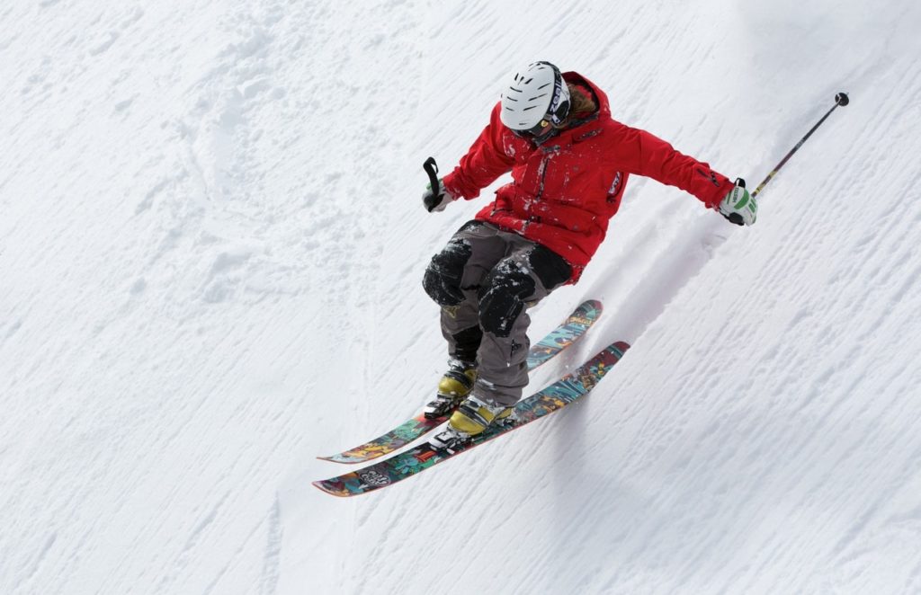 A skier flying down a snowy slope.
