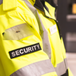 A close up of a security badge on a yellow safety coat.